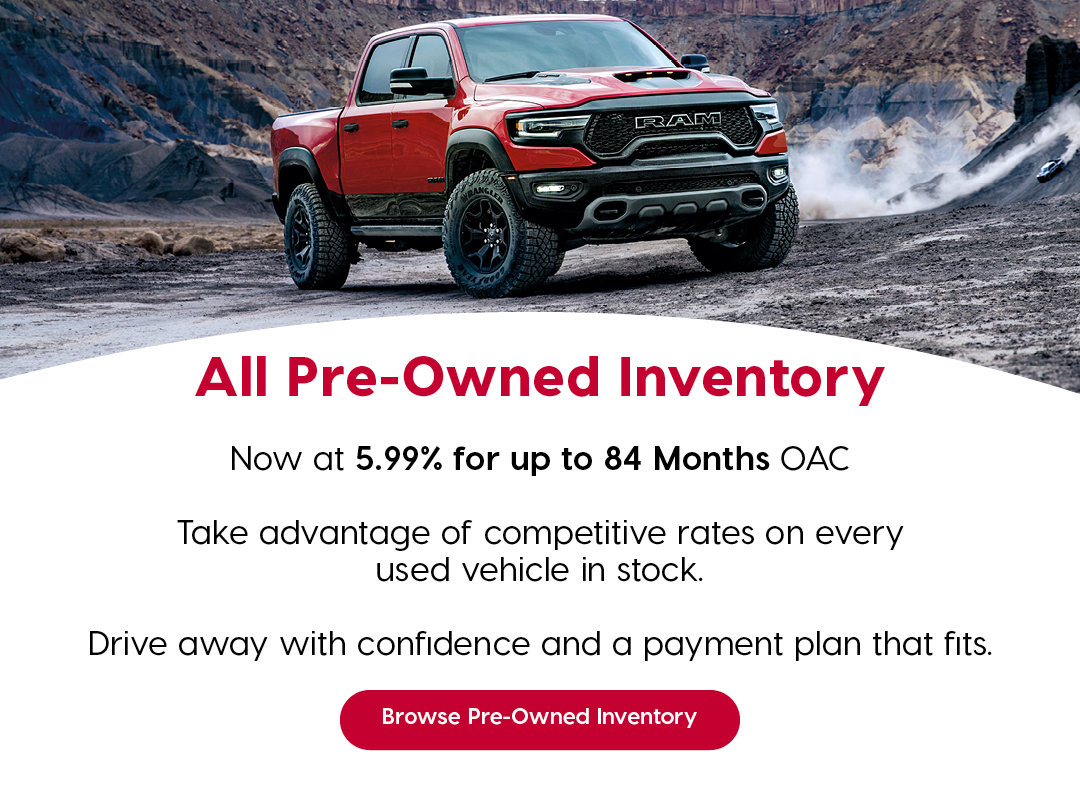 A red Ram 1500 is parked on rugged terrain with a canyon backdrop. Text promotes financing on all pre-owned inventory at 5.99% for up to 84 months OAC. Additional text encourages customers to browse used vehicles, emphasizing competitive rates and flexible payment options. A red button reads “Browse Pre-Owned Inventory.”
